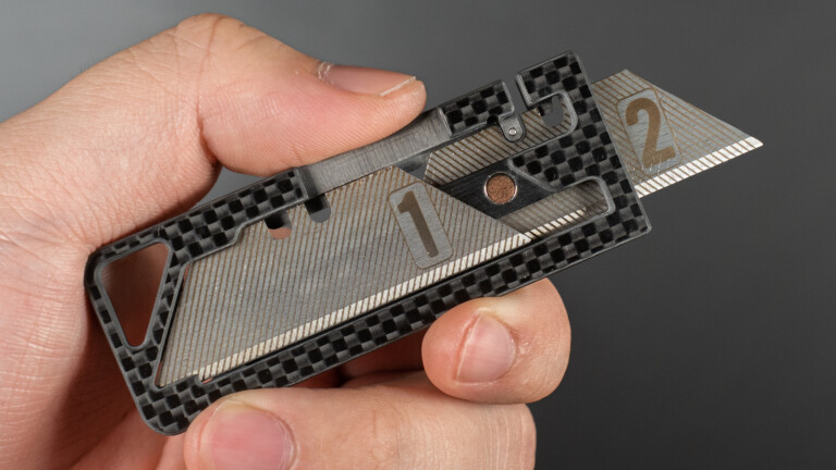 Duplex sleek carbon fiber utility knife has a light design with additional blade storage